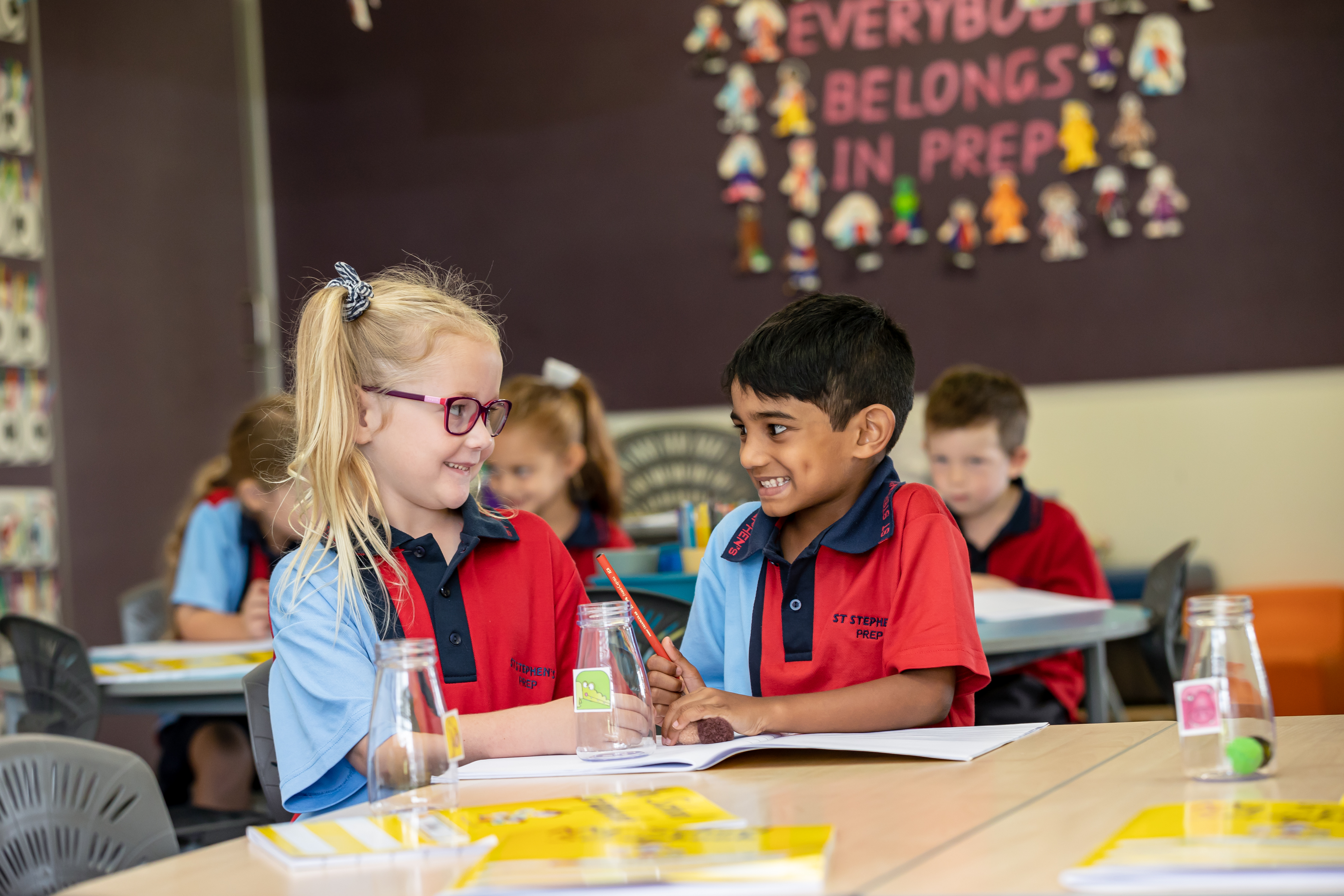 Two prep students sitting at a desk in the classroom.